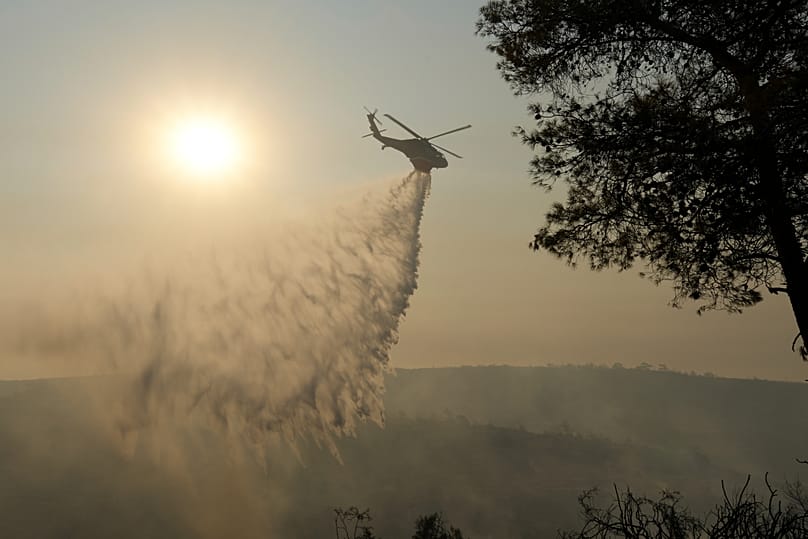 A helicopter drops water over Souni, in Cyprus, 24 July 2025
