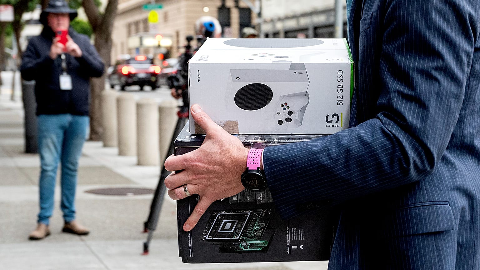 Xbox consoles are carried into a US federal courthouse in San Francisco as Microsoft defends its proposed takeover of Activision Blizzard. 28 June 2023.