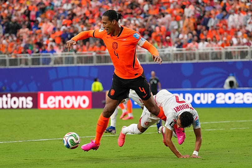 Netherlands' Virgil van Dijk vies for the ball with Tunisia's Elias Achouri during the World Cup Group F match in Kansas City, Mo, Thursday, June 25, 2026