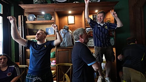 Scotland soccer fans with the Tartan Army play bagpipes, chant and dance in the Ball and Chain music bar 