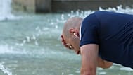 A man refreshes in a fountain at the Sfoza Castle in downtown Milan, Italy, Thursday, June 25, 2026. 