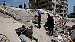 Residents and rescue workers search for survivors in Catia aa Mar, Venezuela, Friday, June 26, 2026, two days after twin earthquakes struck the country.
