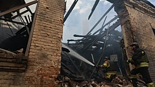 Rescue workers put out a fire at a building destroyed after a Russian strike on Zaporizhzhia, Ukraine, on Friday, June 26, 2026.