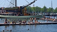 People cool off near the replica of a 18th-century VOC (Dutch East India Company) vessel during a heatwave in Amsterdam, Netherlands, Thursday, June 25, 2026.