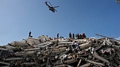 Rescue workers search through the rubble three days after earthquakes struck Catia La Mar, Venezuela, Saturday, June 27, 2026. (AP Photo/Fernando Vergara)