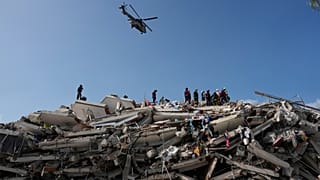 Rescue workers search through the rubble three days after earthquakes struck Catia La Mar, Venezuela, Saturday, June 27, 2026. (AP Photo/Fernando Vergara)