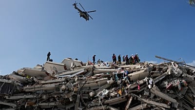Rescue workers search through the rubble three days after earthquakes struck Catia La Mar, Venezuela, Saturday, June 27, 2026. (AP Photo/Fernando Vergara)