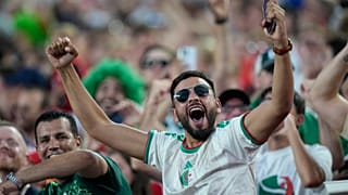 An Algeria fan cheers before the World Cup Group J soccer match between Algeria and Austria in Kansas City