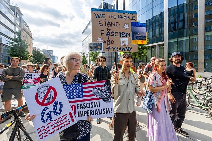 Protestors demonstrate against the America 250 event taking place in the Cinquantenaire Park in Brussels, Sunday, June 28, 2026. (AP Photo/Geert Vanden Wijngaert)