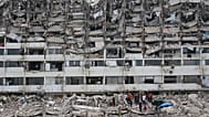 Rescue workers search through the rubble of a building that collapsed when earthquakes struck La Guaira, 28 June, 2026