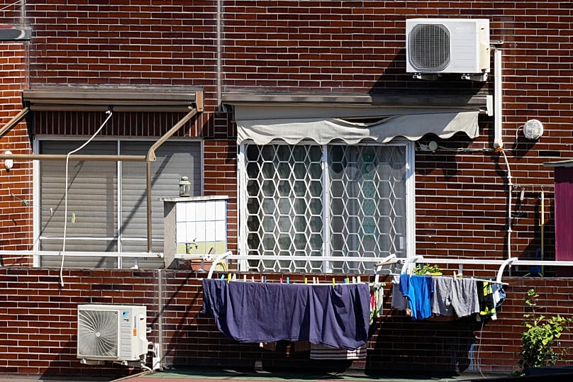 Air conditioning external units are seen on the facade of a building in Rome, Tuesday, July 25, 2023. 