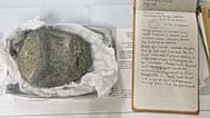 El cuaderno de campo geológico de 1985 perteneciente a Thomson, del British Antarctic Survey, junto a la primera vértebra fósil de dinosaurio encontrada en la Antártida.