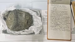 Thomson’s 1985 geological field notebook from the British Antarctic Survey, alongside the first fossil dinosaur vertebra found in Antarctica.