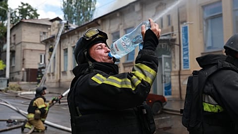 Rescue workers put out a fire at a building destroyed after a Russian strike on Zaporizhzhia, 26 June, 2026