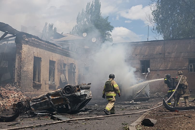 Rescue workers put out a fire at a building destroyed after a Russian strike on Zaporizhzhia, 26 June, 2026
