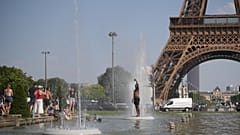 People cool off at Trocadero fountain near the Eiffel Tower during a heat wave in Paris, Wednesday, June 24, 2026. 