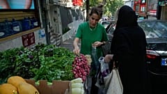 Women buy vegetables in northern Tehran, Iran