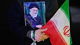 FILE: A demonstrator holds a portrait of the slain Ayatollah Ali Khamenei,  killed in US and Israeli strikes on 28 February, in Tehran, 24 May 2026