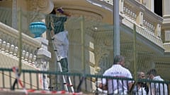 An investigator examines the scene at the residential building where an explosive device seriously injured three people in Monaco, 30 June, 2026