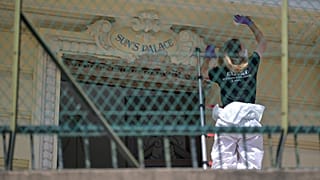 An investigator examines the scene at the residential building where an explosive device seriously injured three people in Monaco, 30 June, 2026