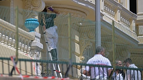 An investigator examines the scene at the residential building where an explosive device seriously injured three people in Monaco, 30 June, 2026