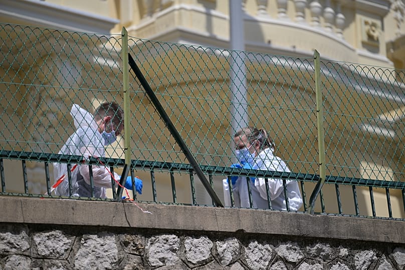 Investigators examine the scene at the residential building where an explosive device seriously injured three people a day earlier in Monaco, 30 June, 2026