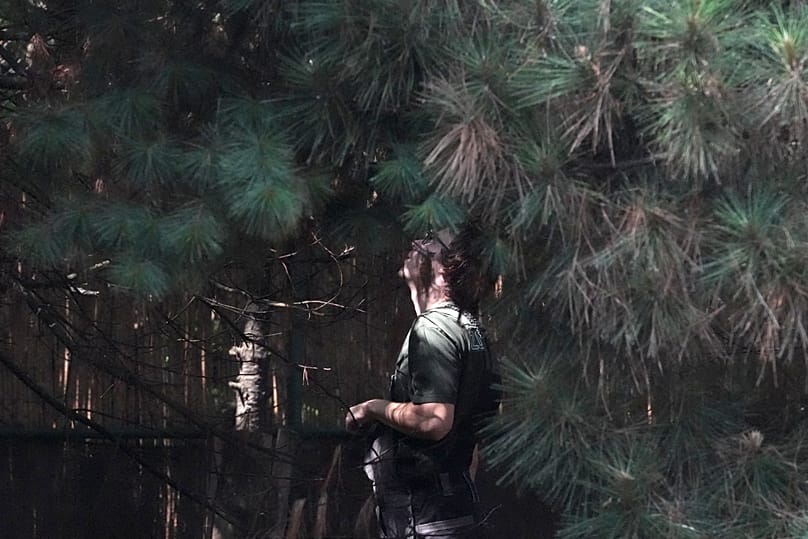 A worker inside the cage at Palic Zoo looks among trees for Feliks, 24 June, 2026