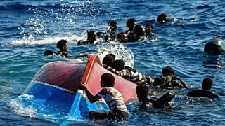 Migrants from Syria and Libya in a wooden boat call for help south of the Italian island of Lampedusa, 11 August, 2022