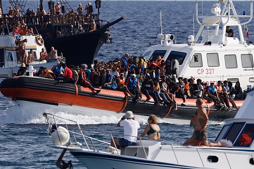An Italian Coast Guard boat carries migrants near the port of the Sicilian island of Lampedusa, 18 September, 2023