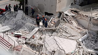 Rescuers search through the rubble of a building that collapsed in the Petralona neighbourhood of central Athens, 30 June, 2026