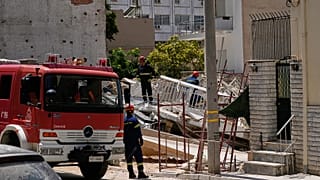 Rescuers search through the rubble of a building that collapsed in the Petralona neighbourhood of central Athens, 30 June, 2026