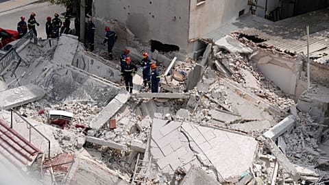 Rescuers search through the rubble of a building that collapsed in the Petralona neighbourhood of central Athens, 30 June, 2026