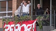 Investigative journalist Sigfrido Ranucci waves from a balcony at the RAI State TV headquarters, hours after an explosive device detonated under his car in Pomezia