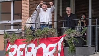 Investigative journalist Sigfrido Ranucci waves from a balcony at the RAI State TV headquarters, hours after an explosive device detonated under his car in Pomezia