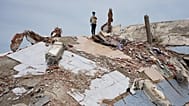 A man stands atop the rubble of a building that collapsed in the earthquakes in La Guaira, Venezuela, Tuesday, June 30, 2026.