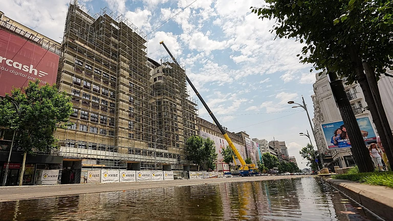 A portion of a main boulevard, with one lane flooded is blocked for traffic by police due to risk of roof collapses, in Bucharest, Romania, Wednesday July 1, 2026.