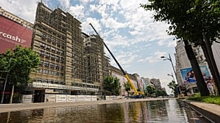 A portion of a main boulevard, with one lane flooded is blocked for traffic by police due to risk of roof collapses, in Bucharest, Romania, Wednesday July 1, 2026.