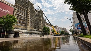 A portion of a main boulevard, with one lane flooded is blocked for traffic by police due to risk of roof collapses, in Bucharest, Romania, Wednesday July 1, 2026.
