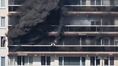 Rescue workers look for victims on upper floors after an apartment block fire in Linkeroever, 1 July, 2026