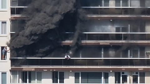 Rescue workers look for victims on upper floors after an apartment block fire in Linkeroever, 1 July, 2026