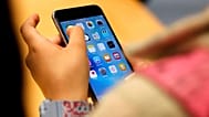 FILE - A child holds an iPhone at an Apple store on Sept. 25, 2015 in Chicago. (AP Photo/Kiichiro Sato, File)