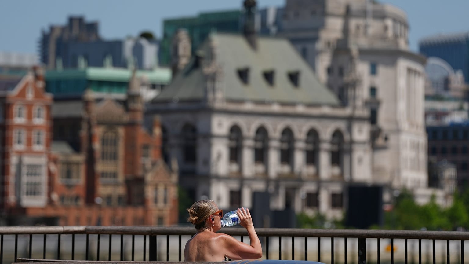A woman takes a drink in London, 23 June, 2026