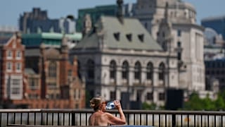 A woman takes a drink in London, 23 June, 2026
