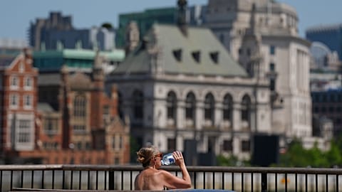 A woman takes a drink in London, 23 June, 2026