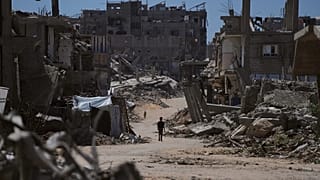 A Palestinian child walks along a street surrounded by buildings destroyed in Israeli military strikes in Khan Younis, 1 July, 2026