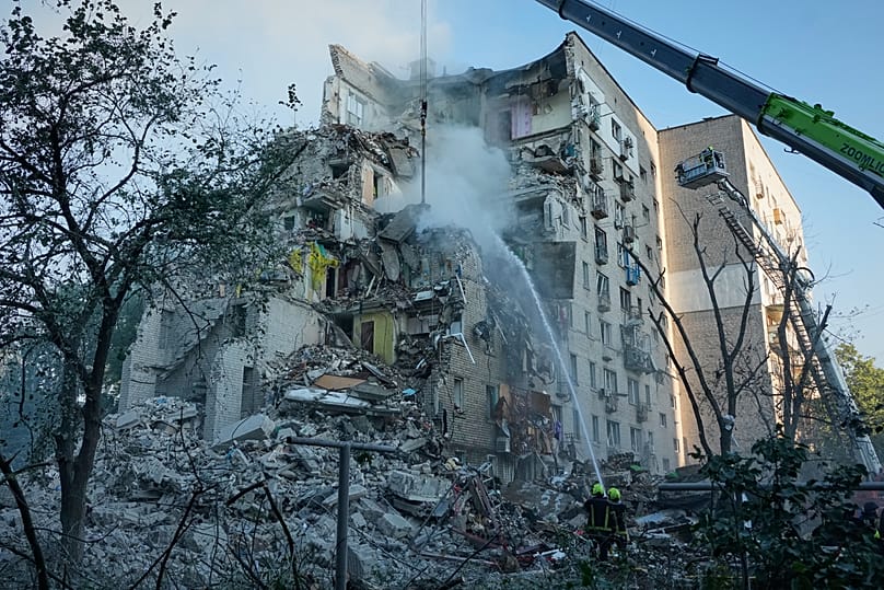 Emergency services personnel work to extinguish a fire after a Russian strike on Kyiv, 2 July, 2026