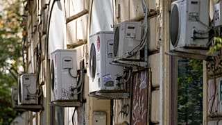 Air conditioning external units are seen on the wall of a building in Rome, Tuesday, July 25, 2023.