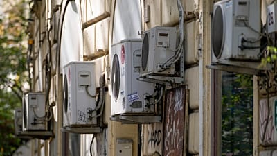 Air conditioning external units are seen on the wall of a building in Rome, Tuesday, July 25, 2023.
