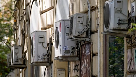 Air conditioning external units are seen on the wall of a building in Rome, Tuesday, July 25, 2023.