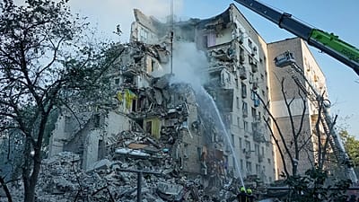 Emergency services personnel work to extinguish a fire after a Russian strike on Kyiv, 2 July 2026.